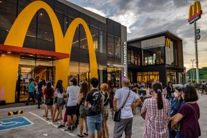 SAN FERNANDO, PHILIPPINES - JUNE 18: Customers queue at a McDonald's restaurant during the launch of the BTS Meal on June 18, 2021 in San Fernando, Pampanga province, Philippines. Long queues formed in several McDonald's restaurants in the Philippines as fans of the K-pop group BTS flocked to order the newly launched and wildly popular BTS themed meals. The limited edition celebrity meal "BTS Meal", a collaboration between the fastfood giant and BTS, will be made available in 49 countries. (Photo by Ezra Acayan/Getty Images)